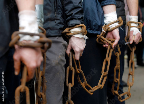 hands of men chained together close up