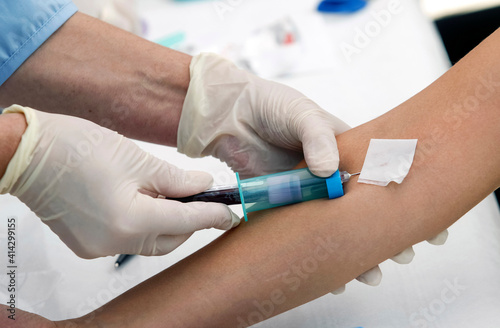 a nurse takes blood test from a child for blood test close up