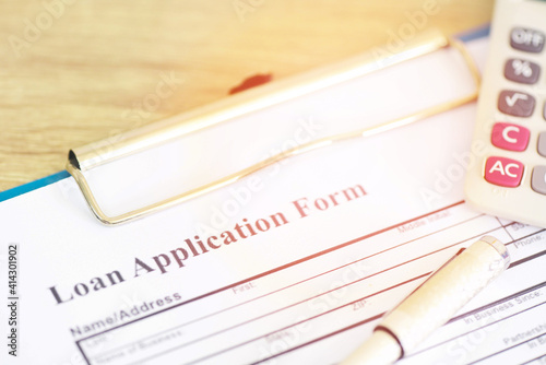 Loan application form, Financial loan money contract agreement company credit or person with a pen filling in information.