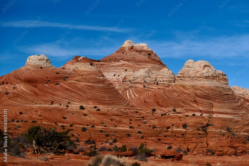 Textured sandstone red buttes under the blue sky. Utah and Arizona states of Southwest. United States of America Textured sandstone red buttes under the blue sky. Utah and Arizona states of Southwest. United States of America