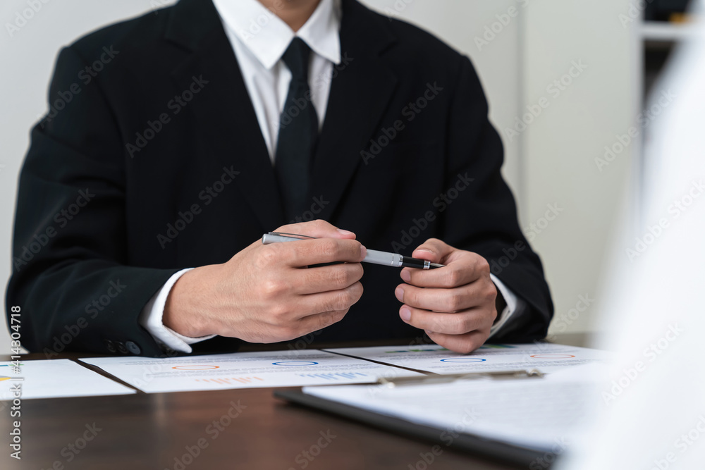 Businessman holds pen and signs agreement contract on the table. Businessman holds pen and signs agreement contract on the table.