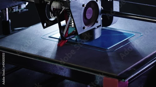 Zoom in close up of 3d Printer printing blue house shot in 4k