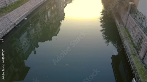 Slow motion of sunrise and reflection on the canal in the city. Eskisehir, Turkey.