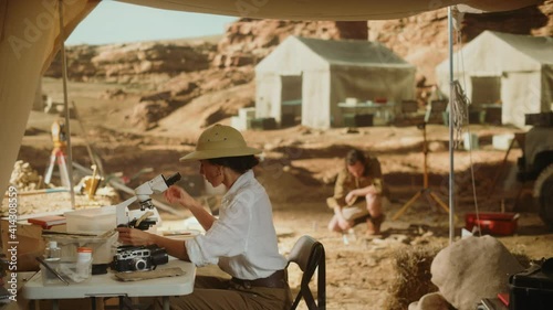 Archaeological Digging Site: Great Female Archaeologist Doing Cultural Research, Discovers Ancient Civilization Historical Artifacts, Fossil Remains at Excavation Site, Study it Under Microscope
