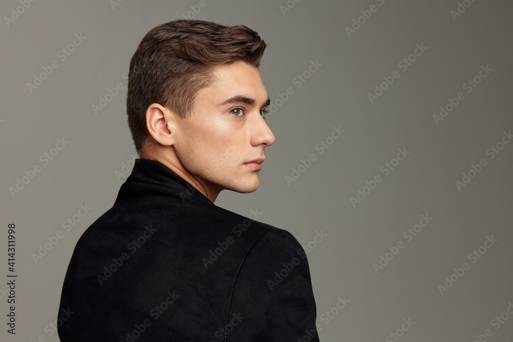 © SHOTPRIME STUDIO - handsome man standing back fashionable hairstyle posing cropped view