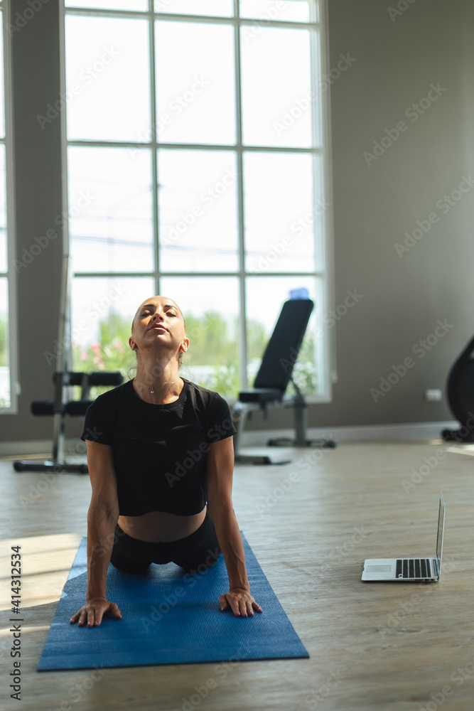 Female sportswear yoga in gym, Woman training at fitness watching videos on laptop. healthcare lifestyle concept. Female sportswear yoga in gym, Woman training at fitness watching videos on laptop. healthcare lifestyle concept.