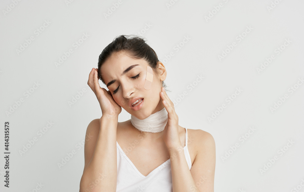 woman in white t-shirt bandaged neck health problems woman in white t-shirt bandaged neck health problems