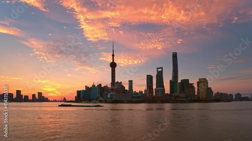 On June 29, 2019 in Shanghai, China. Time-lapse of Lujiazui Financial District in Pudong at sunrise. The Huangpu River and Oriental Pearl TV Tower photo