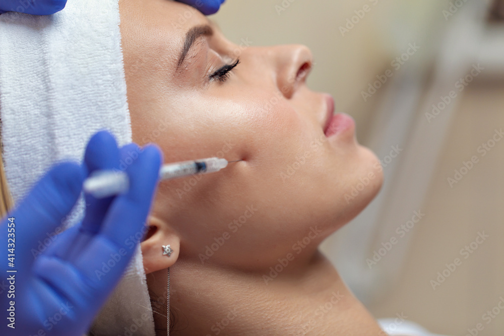 Beauty treatments in the spa salon. Injection of nutrients under the skin of a young girl to nourish and rejuvenate the skin of the face. Skin care concept Beauty treatments in the spa salon. Injection of nutrients under the skin of a young girl to nourish and rejuvenate the skin of the face. Skin care concept