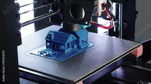 Close up of 3d Printer printing small blue house  shot in 4k