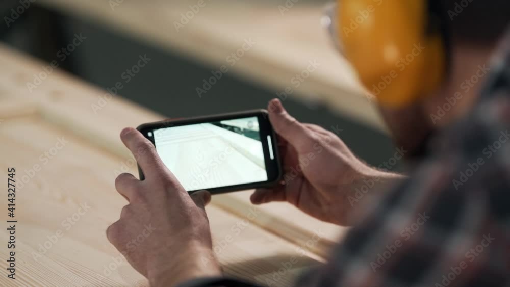Closeup of a phone screen taking off a wooden door