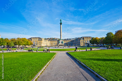 People are walking and resting on the Schlossplatz plaza in Stuttgart, near the New Palace, which was built between 1746 and 1807.