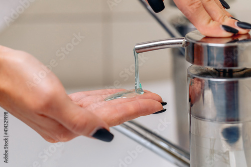 Adorable lovely female hands applying soap to their hands before washing. Water concept. Close-up