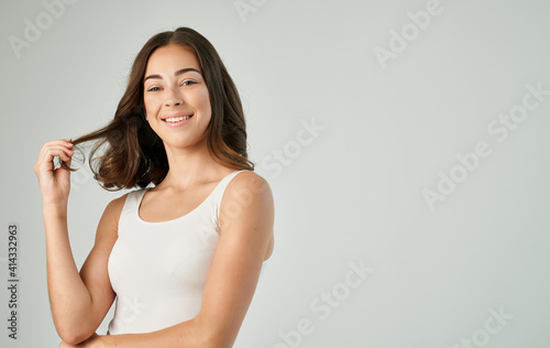 brunette in t-shirt emotions fun cropped view light background