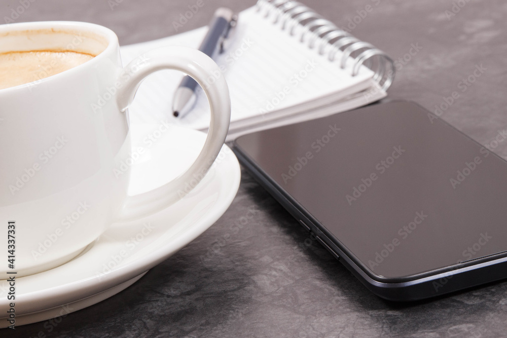 Mobile phone, coffee with milk and notepad for writing notes. Work or relaxation Mobile phone, coffee with milk and notepad for writing notes. Work or relaxation