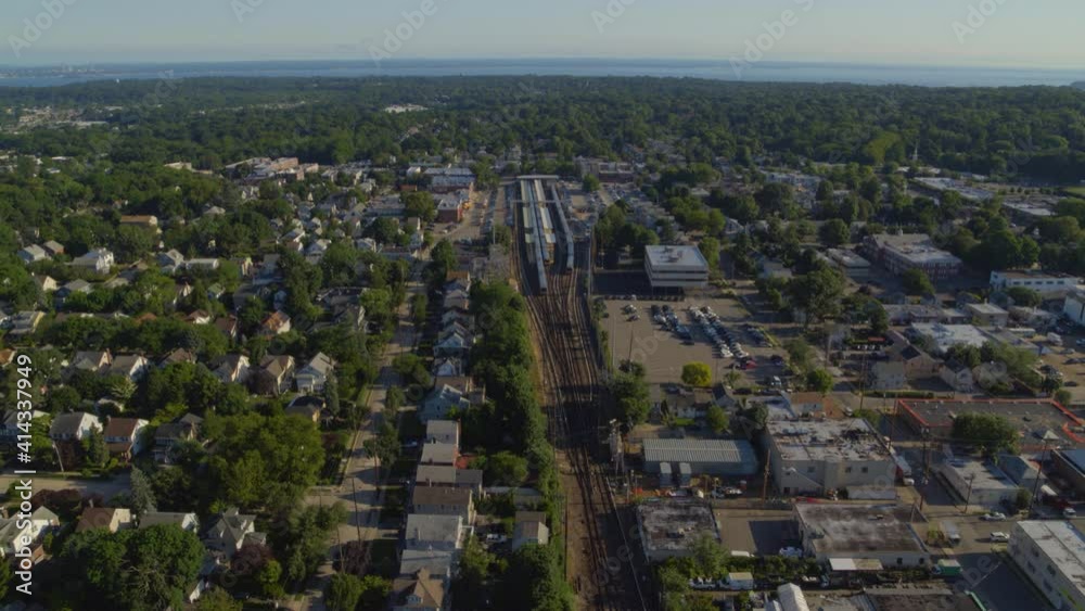 Flying Towards a Train Station in a Small Town in Long Island on a Sunny Day Flying Towards a Train Station in a Small Town in Long Island on a Sunny Day