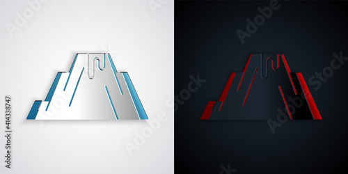 Paper cut Volcano eruption with lava icon isolated on grey and black background. Paper art style. Vector.