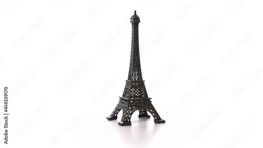 toy metal eiffel tower spins on turntable. Rotation of historic symbol of France with inscription Paris. Miniature replica of the tall tower