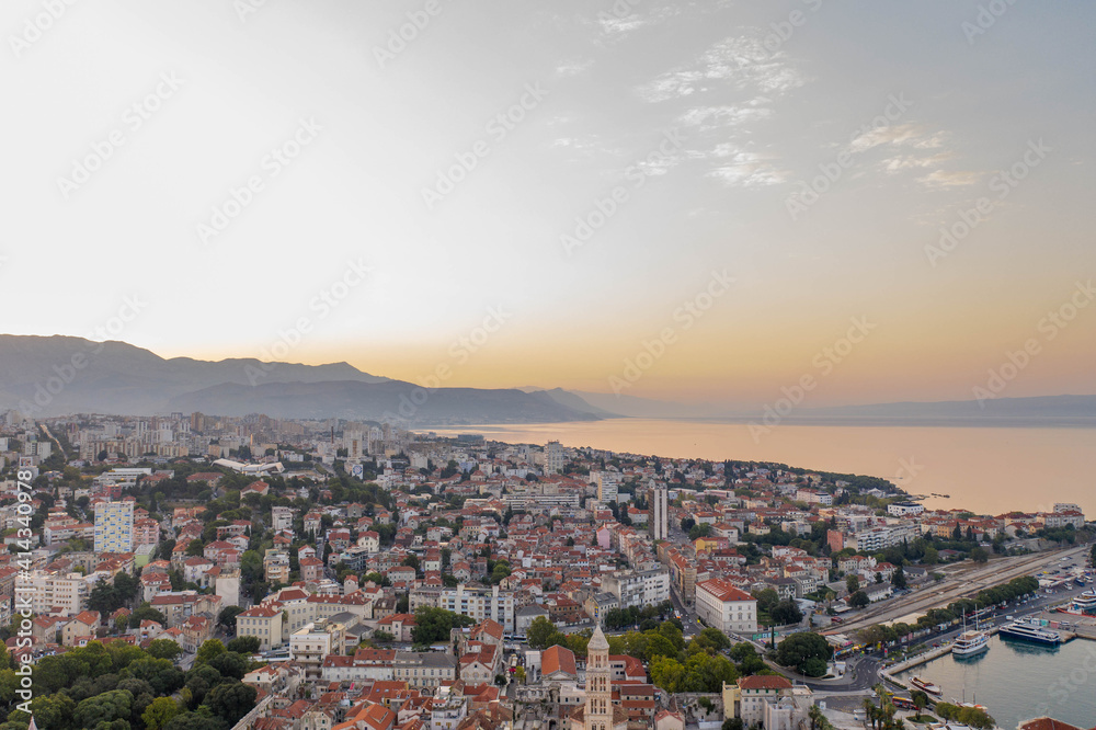 Aerial drone shot of Split city in sunrise hour with view of Mount Morso in Croatia