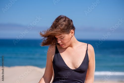 Portrait of woman at beach with ocean in background © rushay