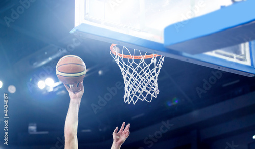 Scoring during a basketball game. Ball in hoop © erika8213