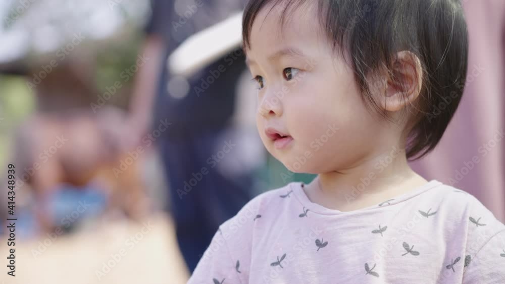 Asian female toddler taking a walk by her self, family time at the park, child development, baby girl toddler beginning of new life, innocence purity of young age, imagination curiosity, close up shot Asian female toddler taking a walk by her self, family time at the park, child development, baby girl toddler beginning of new life, innocence purity of young age, imagination curiosity, close up shot