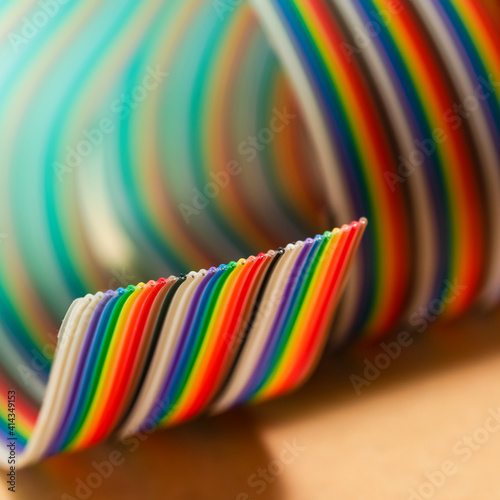 Roll of Colorful Twisted Connecting Wire Strip on Plain Surface.