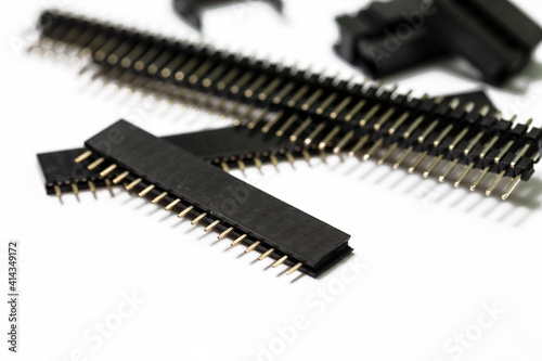 Electronics Components Ideas. Macro Shot of Long Straight PCB Connectors or Terminal Blocks Placed Bulk On White Background.