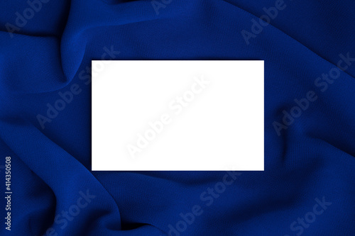 White business card mockup on blue fabric. Template with space for text.