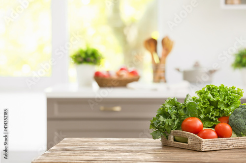 Tray with vegetables on table in modern kitchen