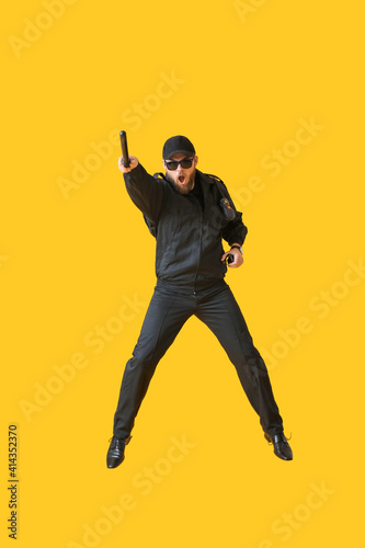 Jumping policeman on color background