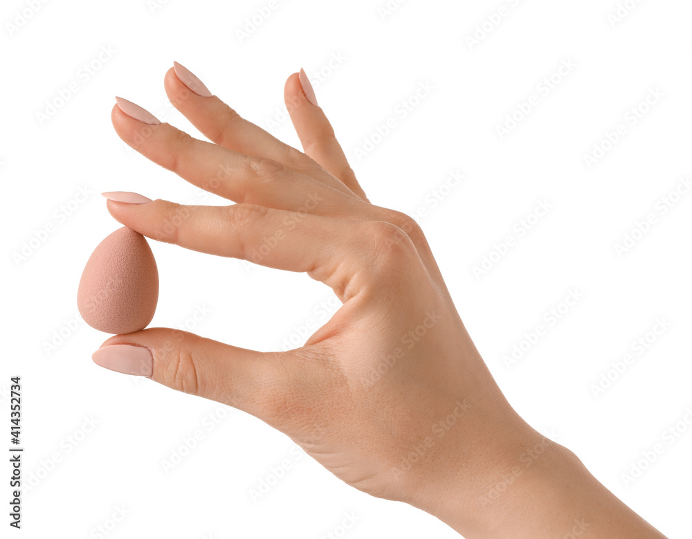 Hand with makeup sponge on white background Hand with makeup sponge on white background