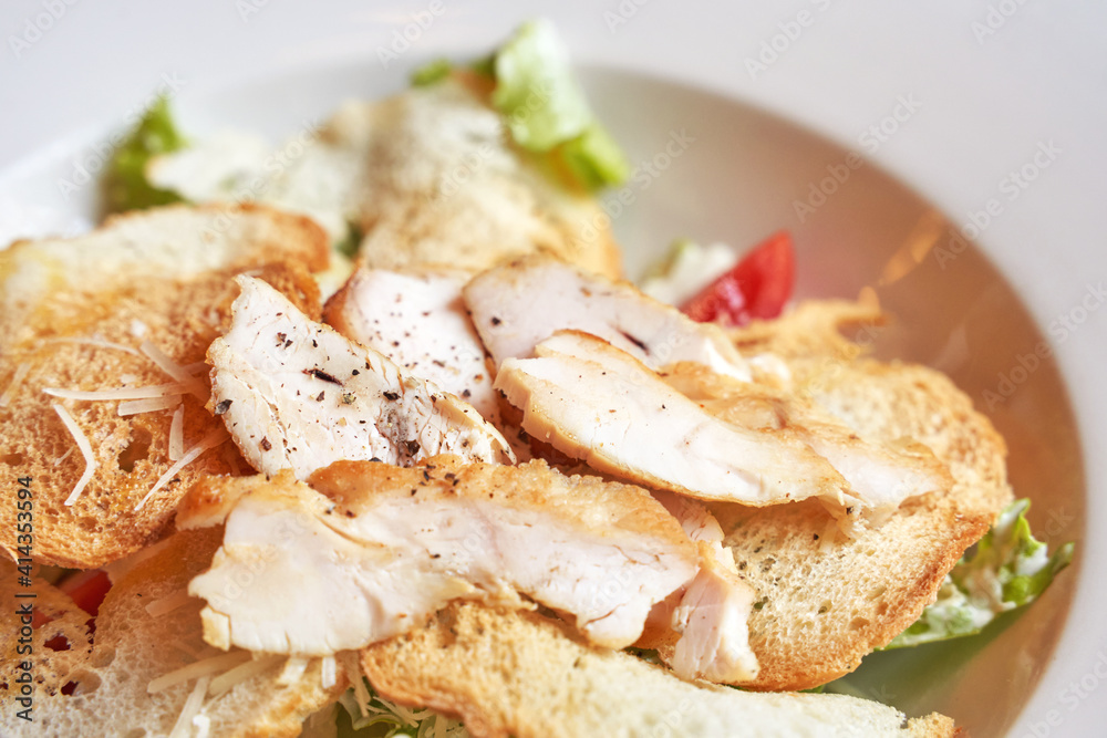 Caesar salad plate. Health food at cafe. Bread crouton, chicken, tomato, cheese in bowl. Top view. Closeup view. Freeshness gourmet. Italian cuisine