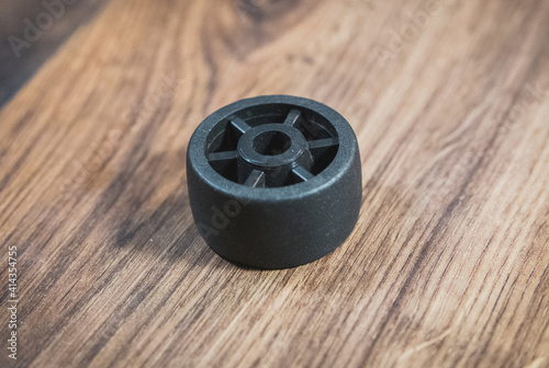 black plastic wheel which will attached to the furniture