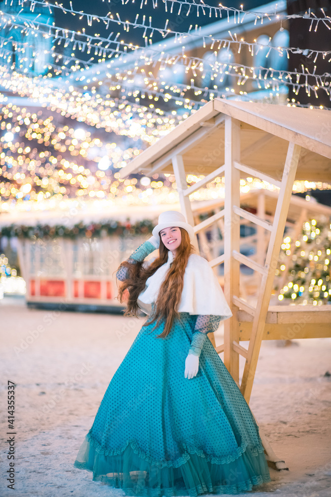 A girl in an old-fashioned dress in winter on the street