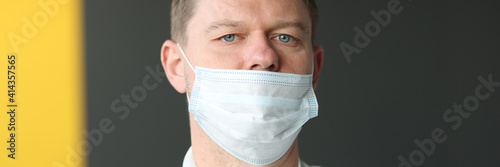 Man with an incorrectly worn protective medical mask.