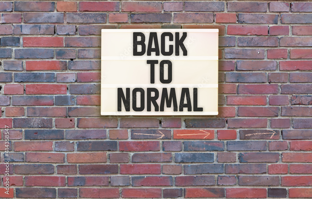 Back To Nomal text in lightbox on brick wall Back To Nomal text in lightbox on brick wall