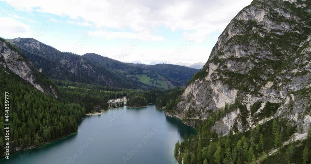 High above Lake prags in South Tyrol, Aerial Landscape in the Alps, Beautiful Lake surrounded by steep Mountains. Outdoor adventure and relax in Nature. Aerial Mountains panning down to white Beach 4K High above Lake prags in South Tyrol, Aerial Landscape in the Alps, Beautiful Lake surrounded by steep Mountains. Outdoor adventure and relax in Nature. Aerial Mountains panning down to white Beach 4K