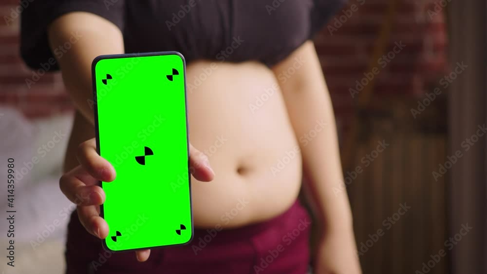 Getting Fat Problem Phone A close-up of the fat woman shows the smartphone. Woman with a thick ...