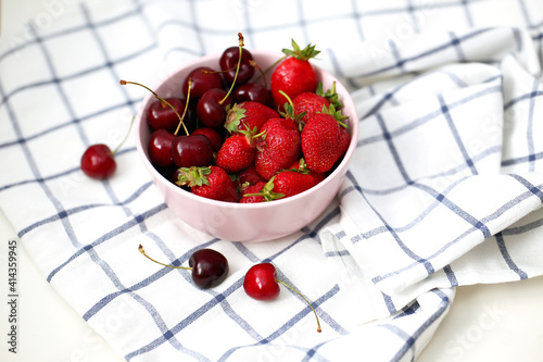 Fresh strawberries and cherries in a plate. Summer berries
