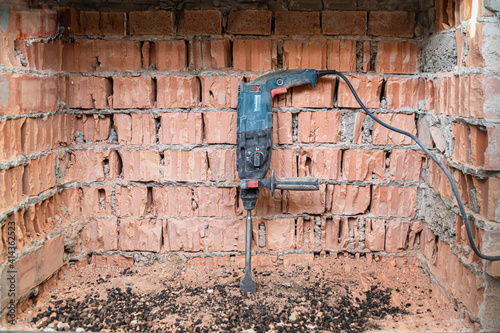 hammer drill on brick background