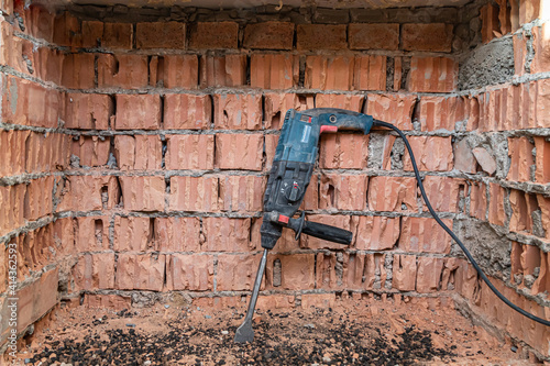 hammer drill on brick background
