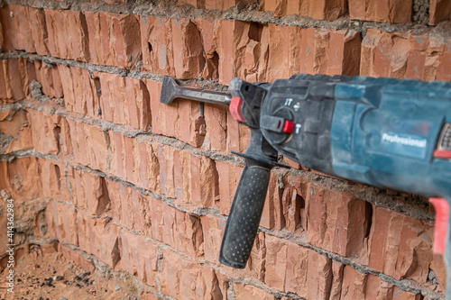 hammer drill on brick background