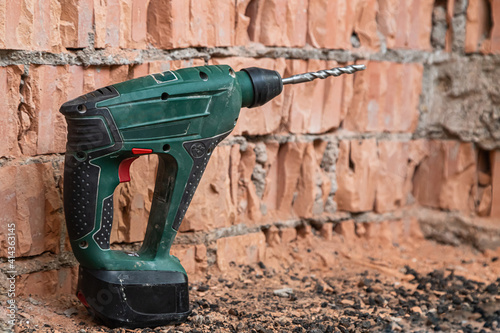 hammer drill on brick background