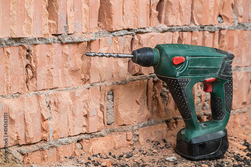 hammer drill on brick background