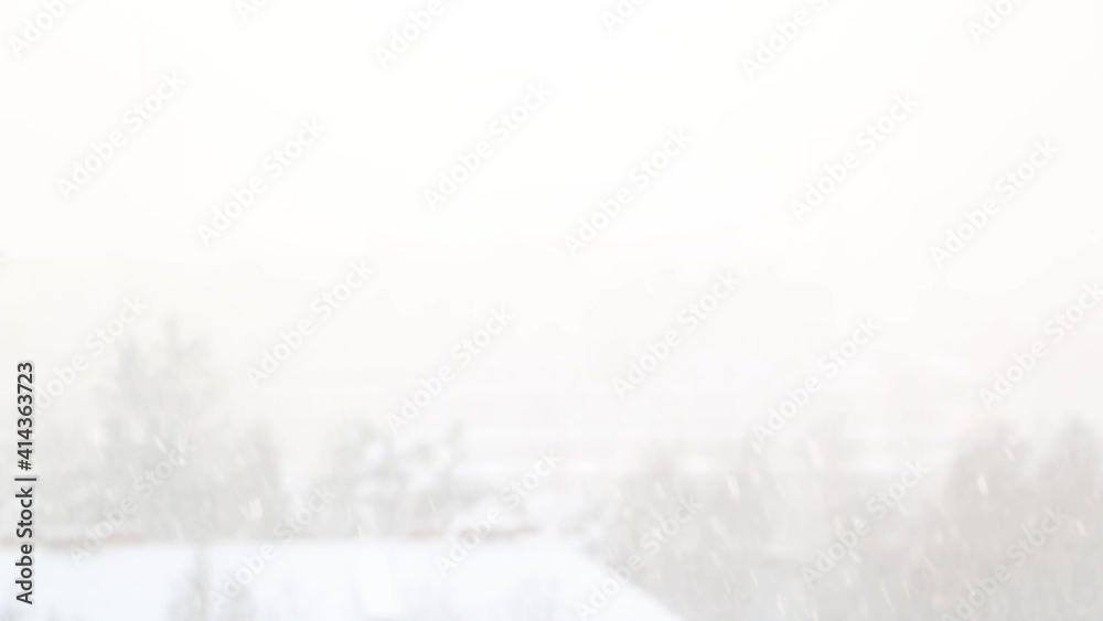 Out of focus. Blurred background. Heavy snow is falling.