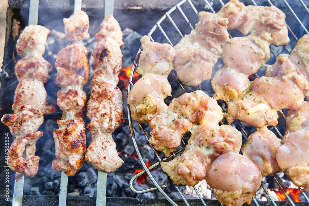 Grilled kebab cooking on metal skewer. Roasted meat cooked at barbecue. BBQ fresh beef meat chop slices. Traditional eastern dish, shish kebab. Grill on charcoal and flame, picnic, street food. Grilled kebab cooking on metal skewer. Roasted meat cooked at barbecue. BBQ fresh beef meat chop slices. Traditional eastern dish, shish kebab. Grill on charcoal and flame, picnic, street food.