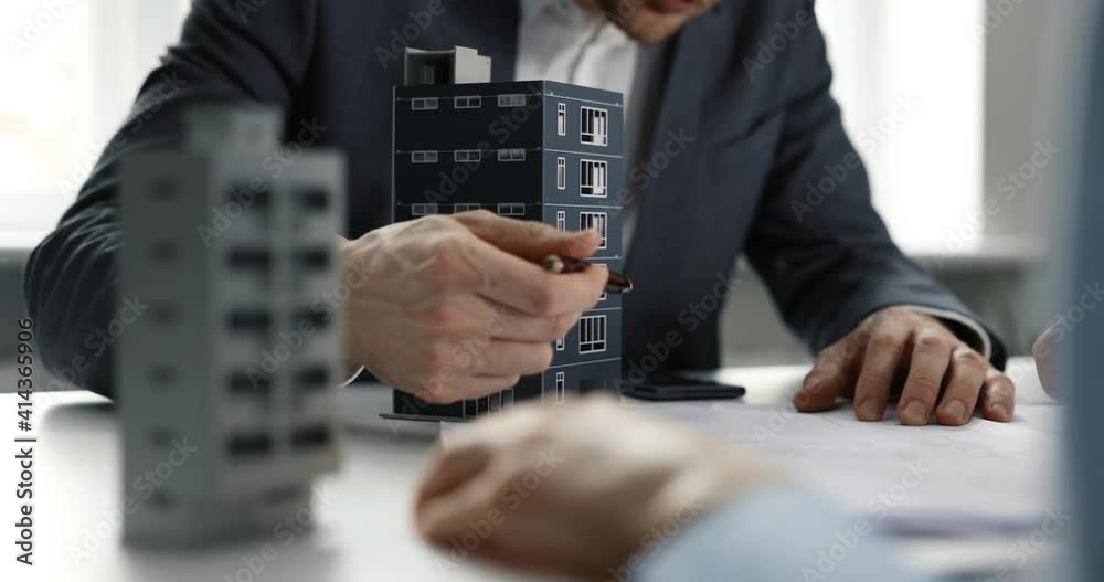 real estate developer and architect discussing new housing development project in office