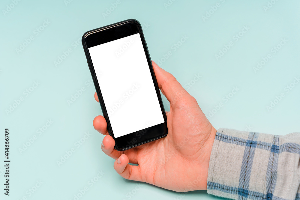 Hands use mobile phone, copy space, blue background Hands use mobile phone, copy space, blue background