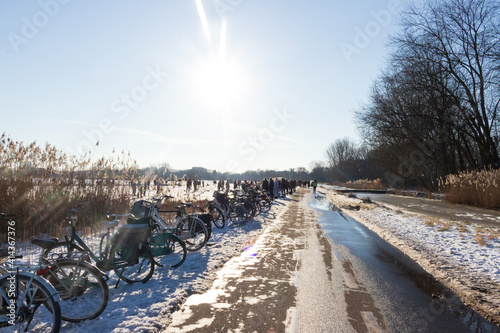 People ice skating on a frozen pond in The Netherlands 